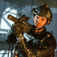A soldier points a gun.